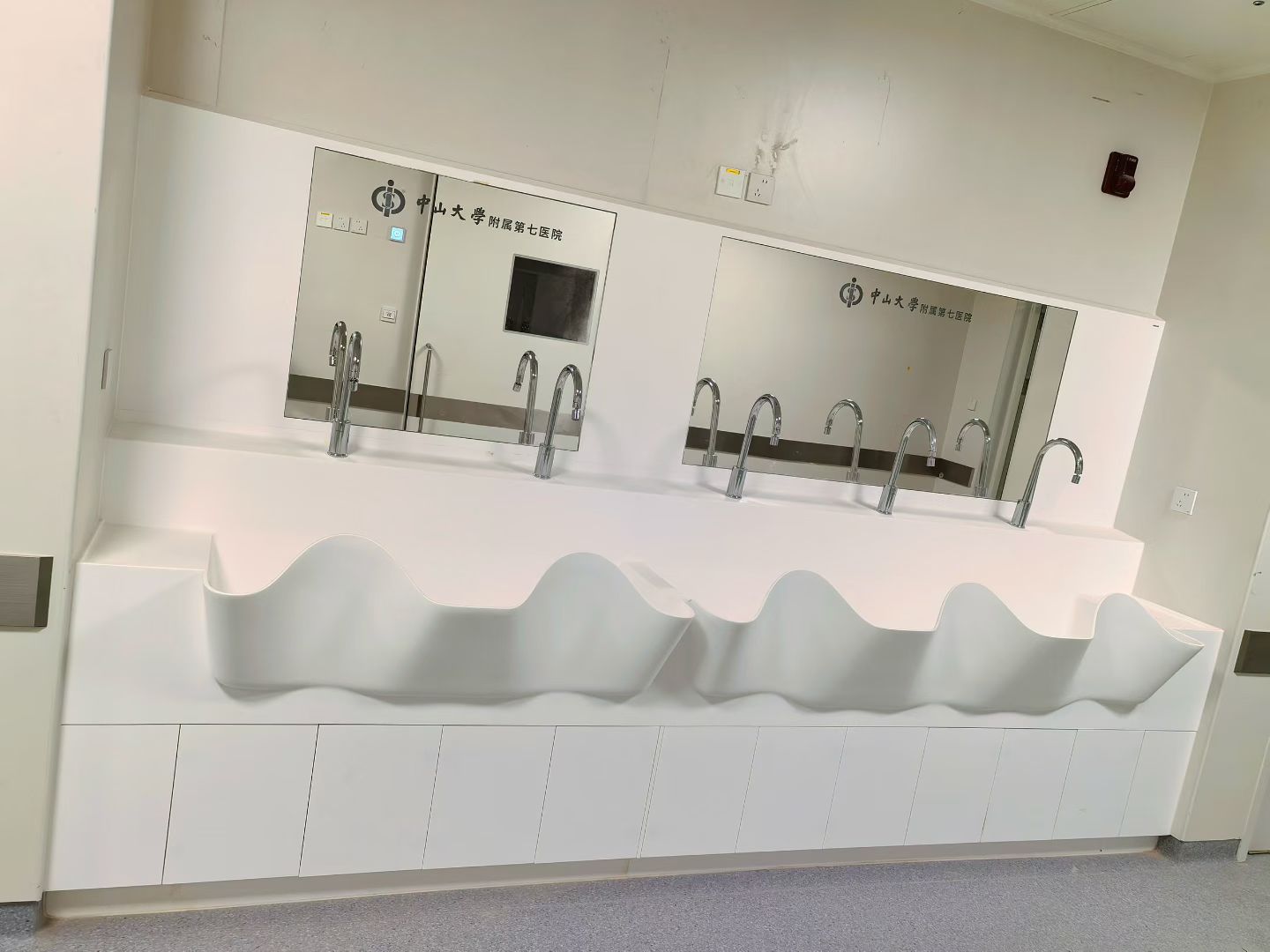 Wall-mounted medical scrub sink with sensor taps