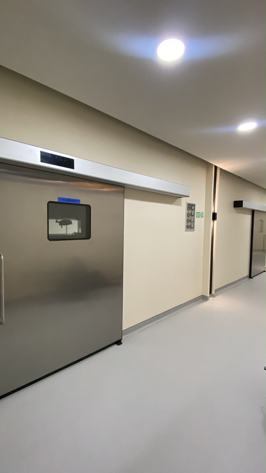 Stainless steel automatic hermetic sliding door in clinical corridor of Bali dental clinic