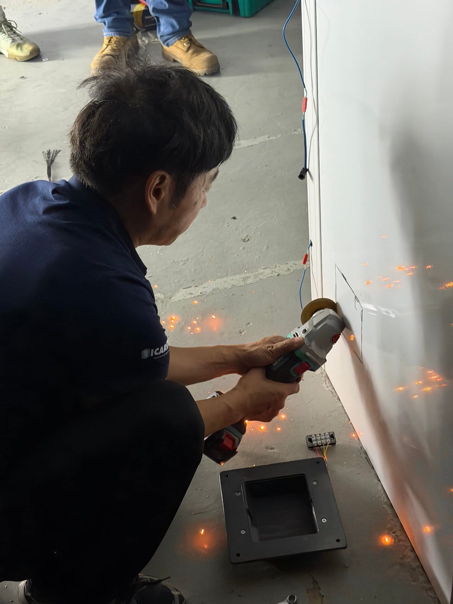 ICARELIFE engineer trimming modular wall panel edge on site in Manila