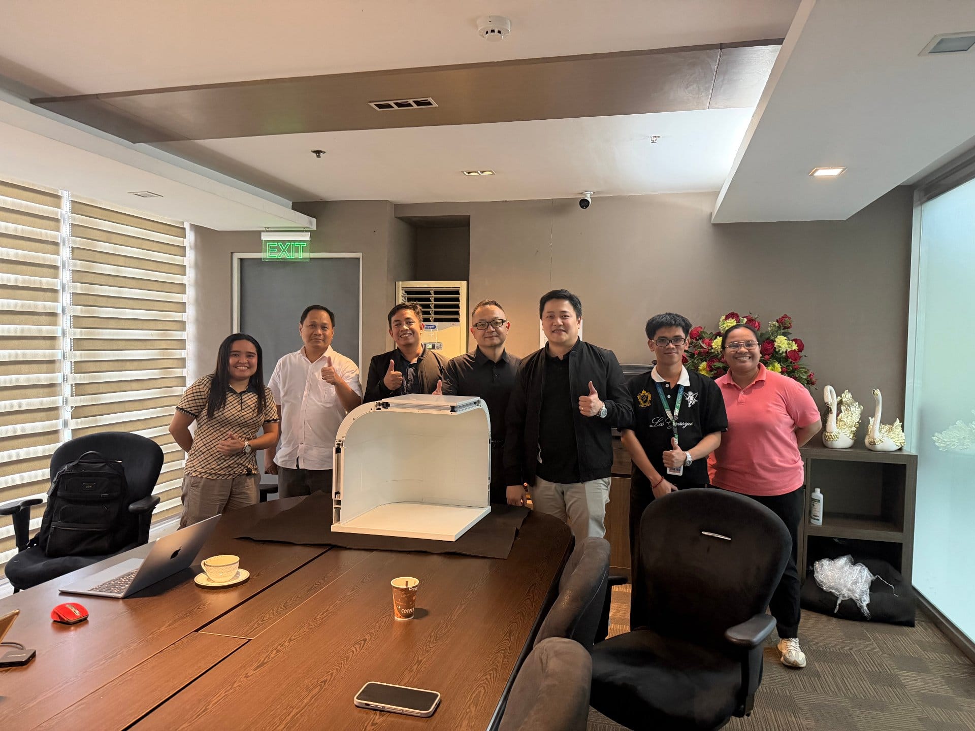 ICARELIFE and Philippine partner team at project kickoff meeting with modular wall sample