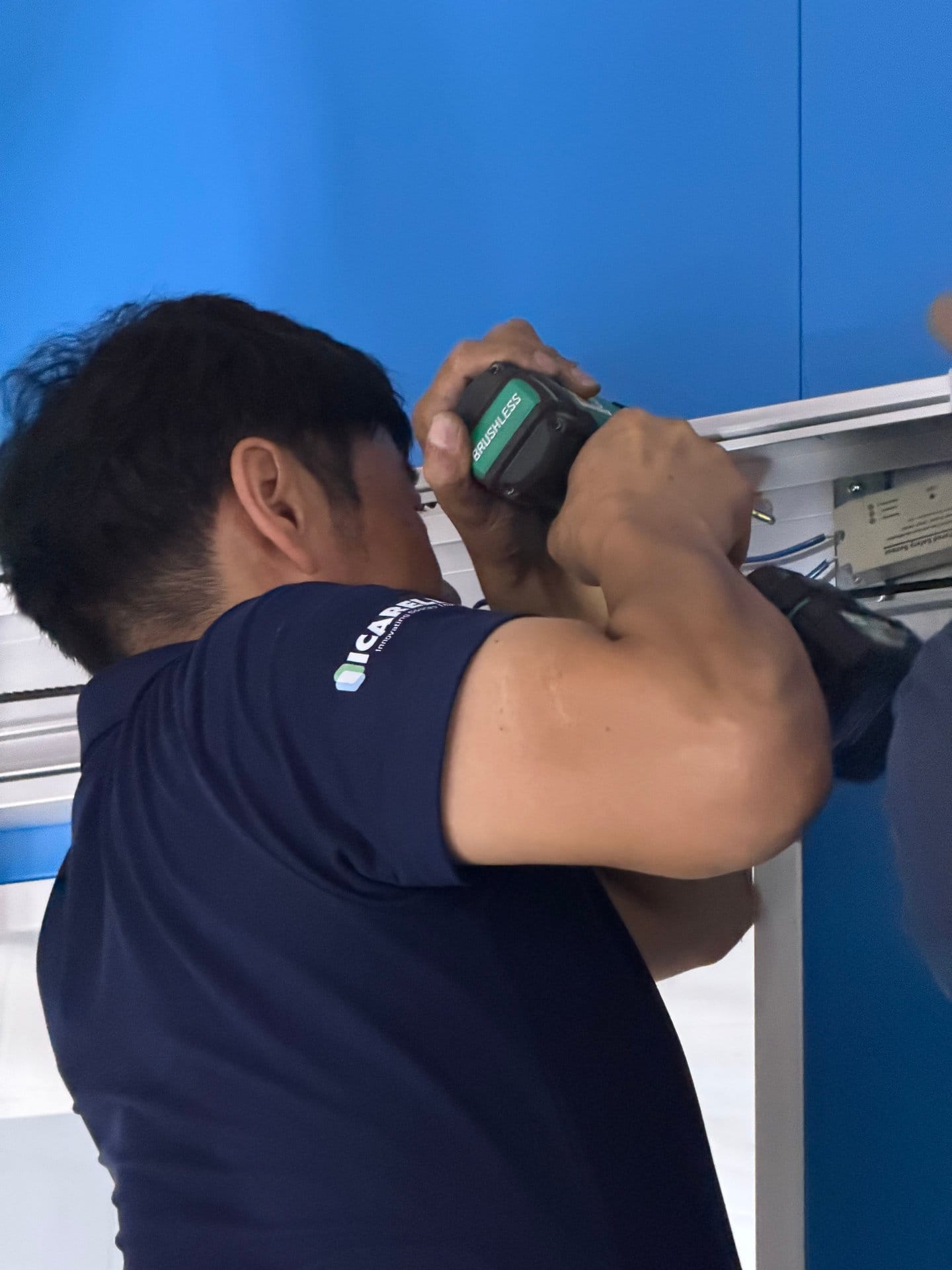 ICARELIFE technician fixing modular wall panel with cordless drill on site in Quezon City