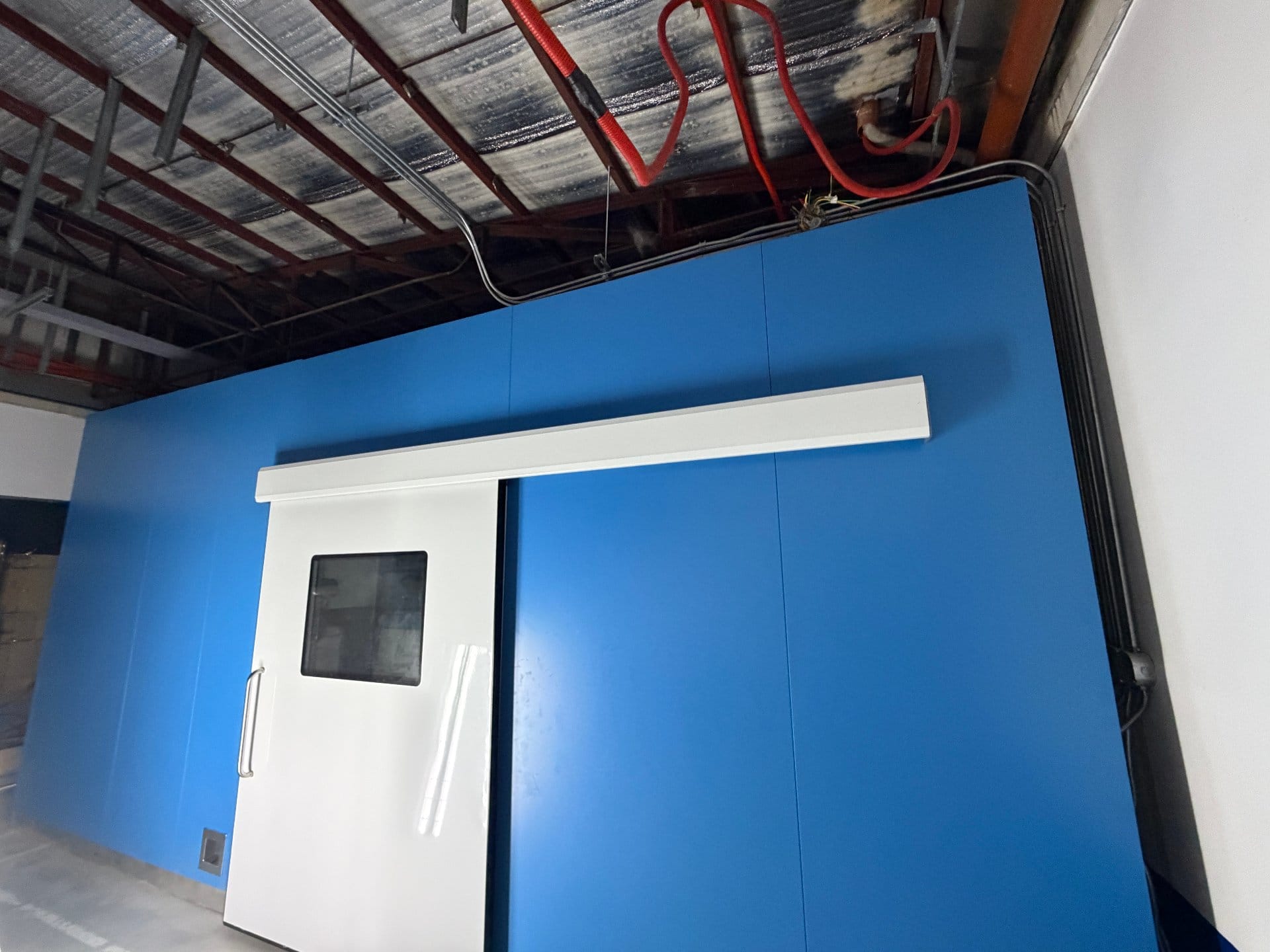 Blue modular wall panels and hermetic sliding door installed in Quezon City showroom
