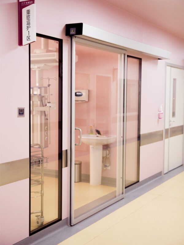 Pink hospital room with glass sliding doors